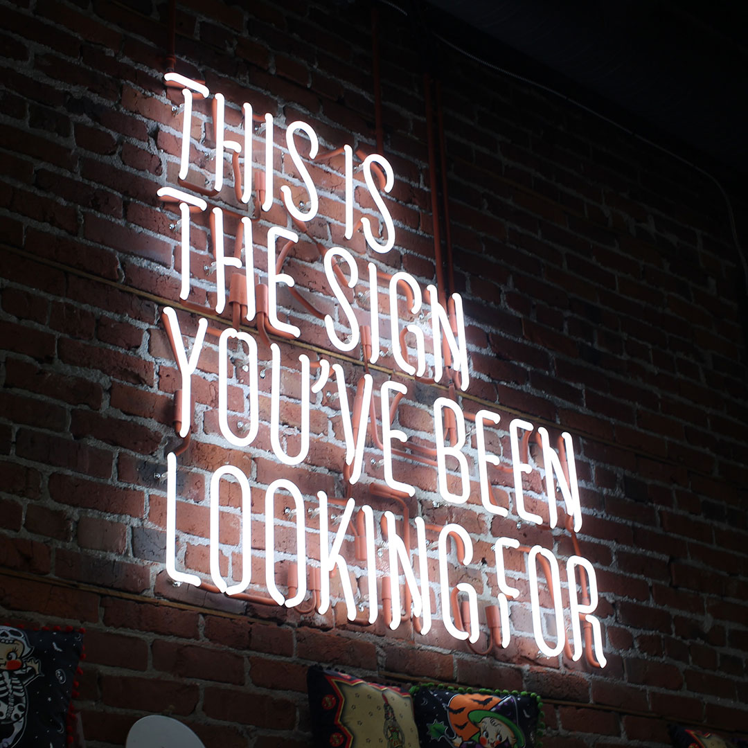 neon sign that says "this is the sign you've been looking for"